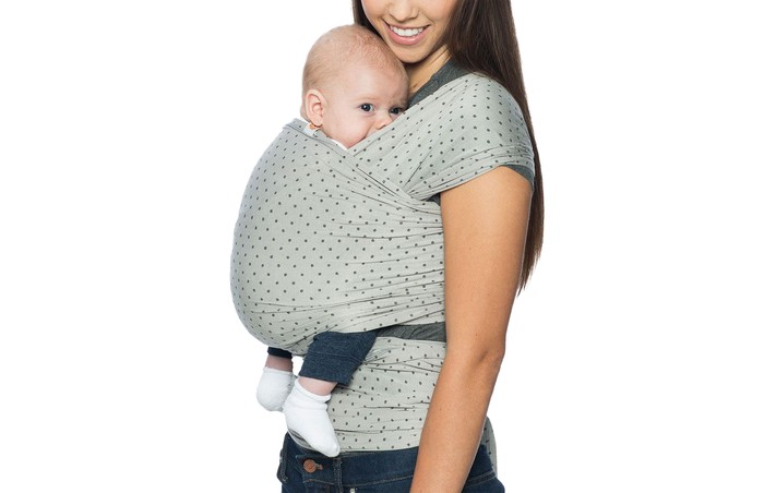 A woman wearing the Ergobaby Aura Baby Wrap with a baby inside
