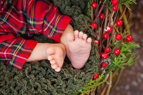 BABY-FEET detail of Scottish baby boy feet and legs wearing tartan trousers
