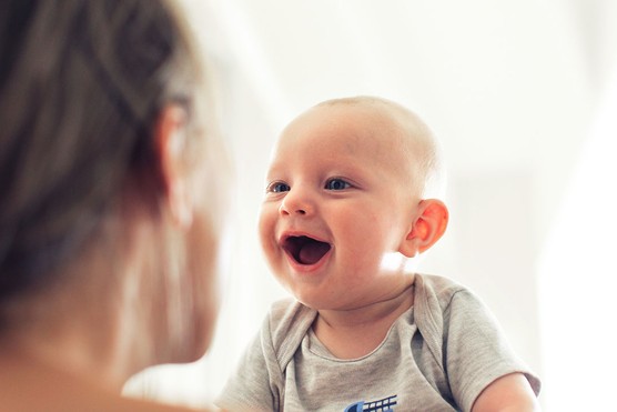baby boy looking at mother and saying first word