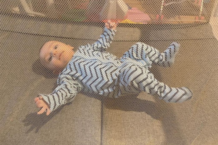 Baby through mesh on Tutti Bambini CoZee Go travel cot