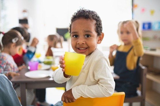 Young child holding a plastic cup