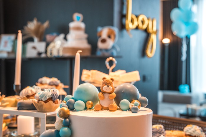 A Display of Baby Shower Decor and Sweet Treats The ultimate Baby shower dessert experience with a beautiful array of luscious treats and a special cake.