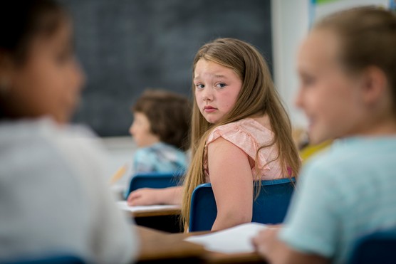 girl at school looking sad and worried