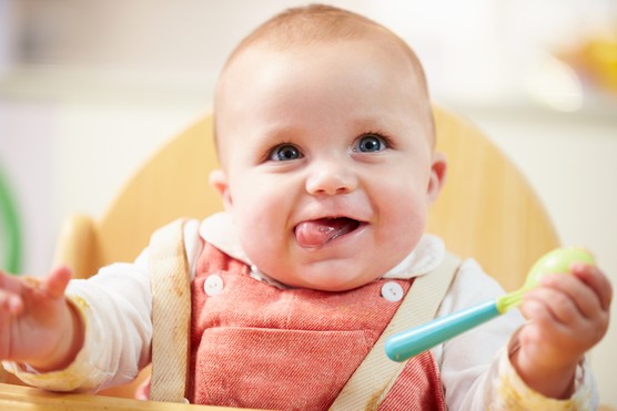 Portrait Of Happy Young Baby Boy In High Chair Portrait Of Happy Young Baby Boy In High Chair Waiting For Food