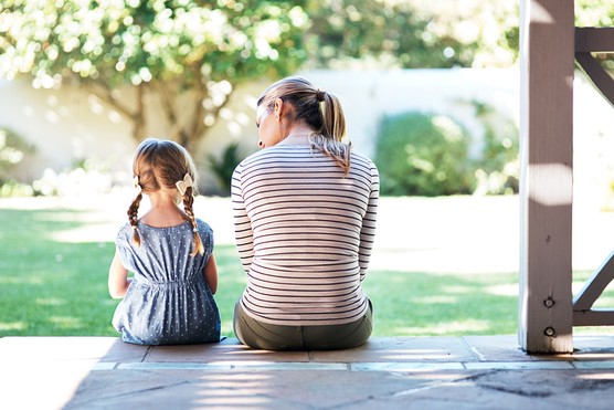 a rearview shot of a mother and daughter talking about their feelings