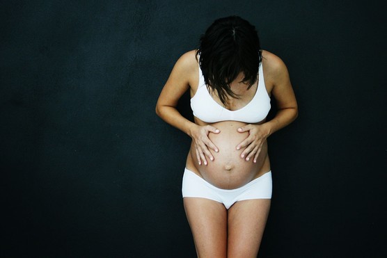 mucus-plug pregnant woman looking down