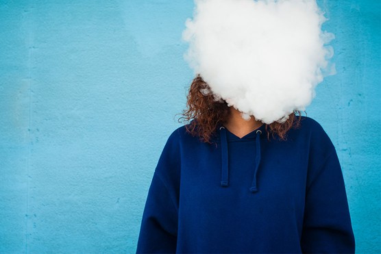 woman with head obscured by smoke from a vape