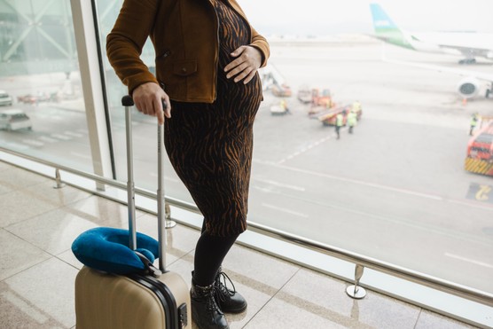 pregnant woman waiting in airport terminal