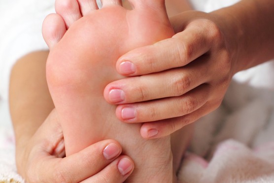 woman holding her feet