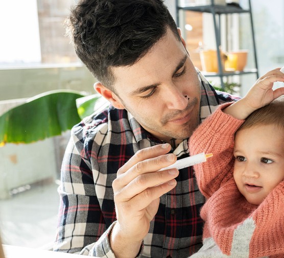 little girl refusing to take medicine her dad is giving her in a syringe
