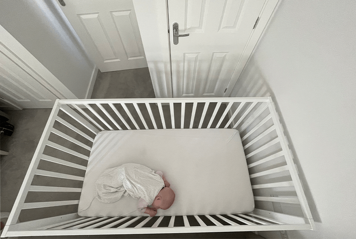 Baby lying in Ickle Bubba Hartley Classic Cot Baby lying in Ickle Bubba Hartley Classic Cot