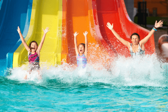 Three people on a waterslide.