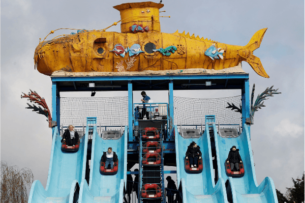 Members of the public ride on the Depth Charge water slide ride at Thorpe Park theme park in Chertsey