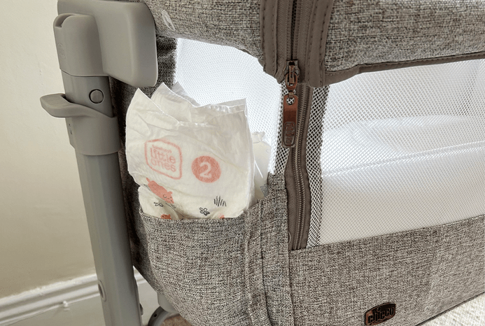 Close-up of storage pocket on Chicco Armonia Next2Me bedside crib
