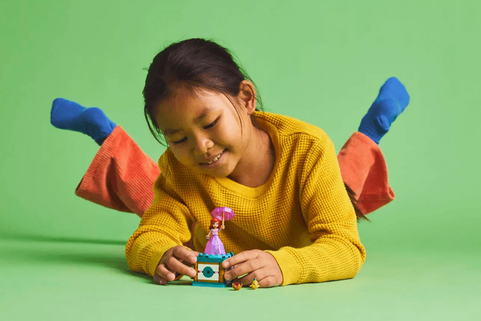 Child playing with Twirling Ariel LEGO toy